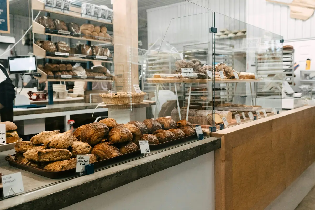 Bakery counter stocked with fresh croissants and loaves, the kind of busy small business that weighs up cash flow loans before the Christmas rush