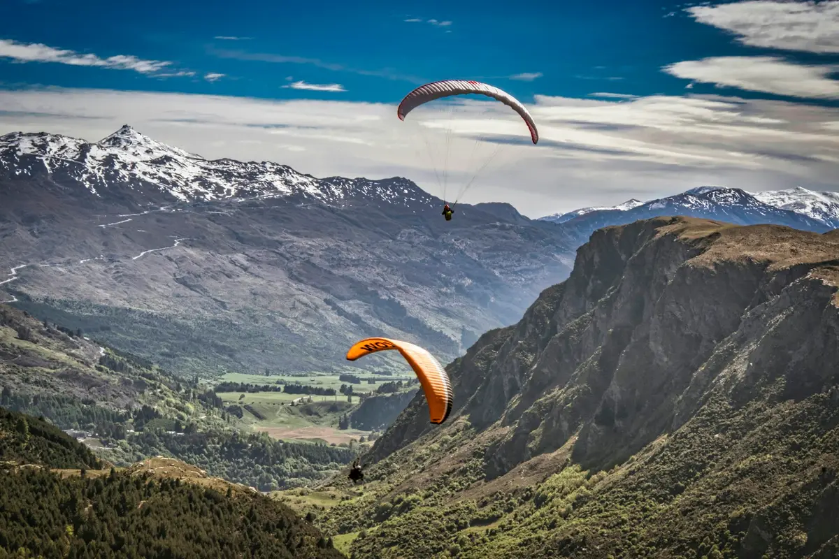 Paragliders over the valley below Bob's Peak in Queenstown