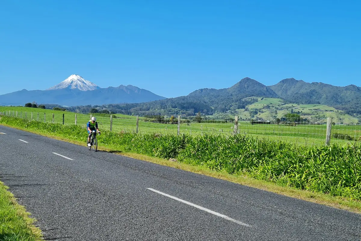 Cyclist on a country road in Taranaki in spring